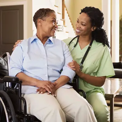 A nurse with a person in a wheelchair